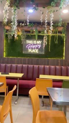 Shree's dining room with a neon sign reading This is my happy place